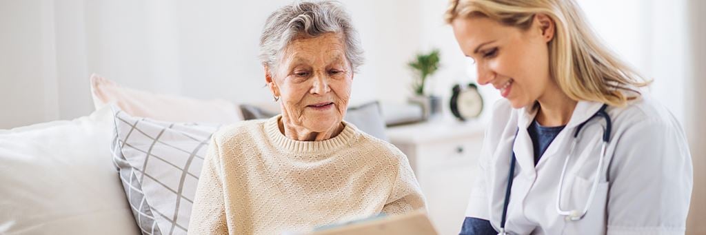 A nurse discusses Medigap coverage with a senior patient.