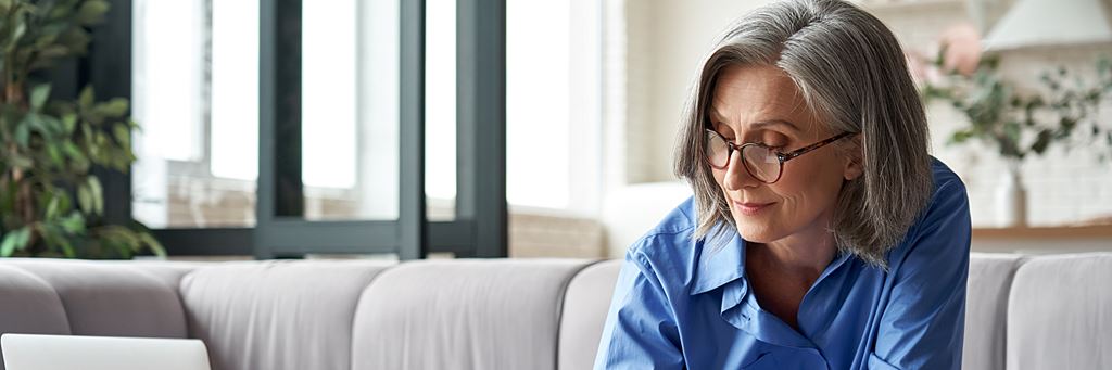 A senior woman takes notes.