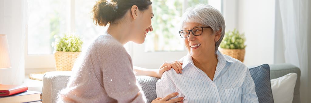 An adult child talks to her parent who has dementia.