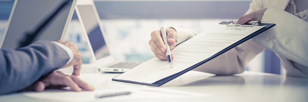 Business person signing a contract.