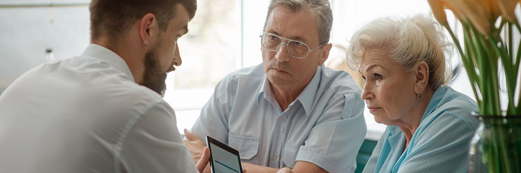 A couple speaks with a financial advisor about guaranteed acceptance life insurance.
