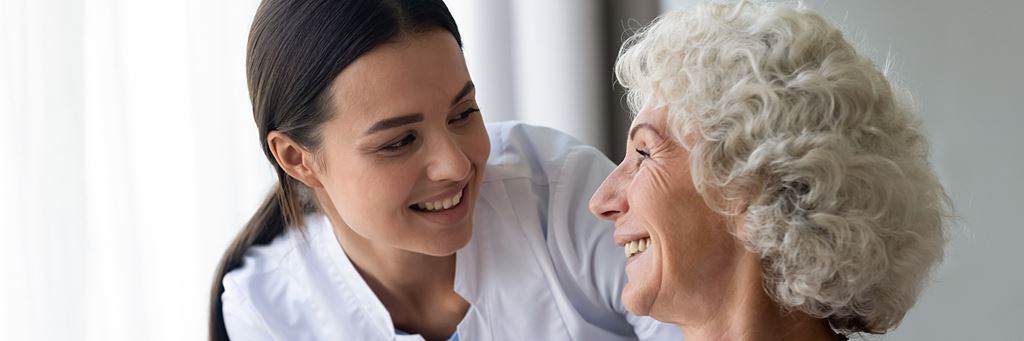 A health care provider smiles at a Medicare-covered patient.