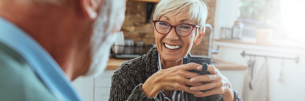 Senior woman drinks a cup of coffee.