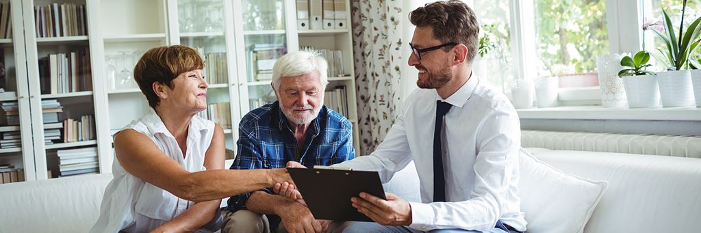 A senior couple discusses their retirement planning with an advisor.