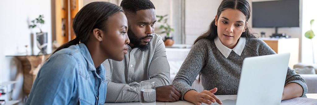 An adult couple meets with their financial advisor to discuss an inherited IRA.