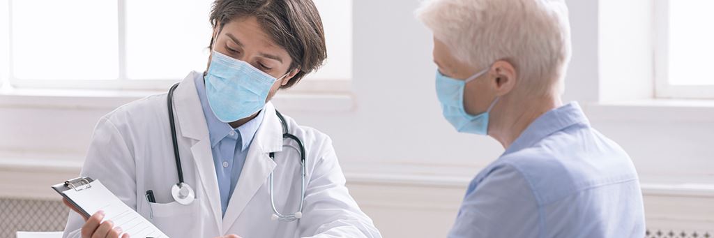 A doctor explains Medicare Part B coverage to a senior patient.