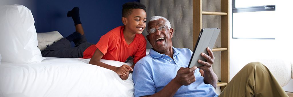 Grandfather reading with grandson.