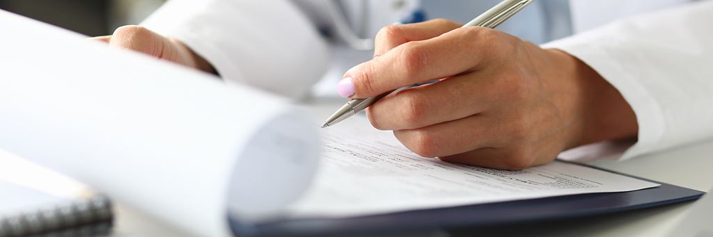 A person fills out a medical application.