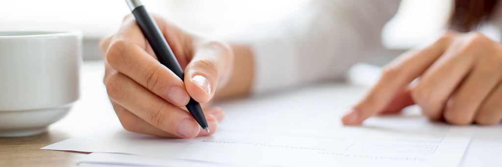 A person filling out paperwork.