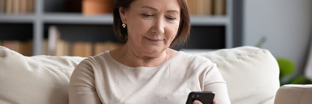 A retiree looks at her phone.