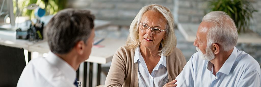 A couple review their taxes with a financial professional.