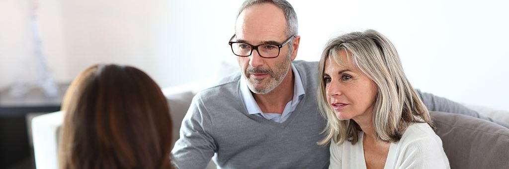 A senior couple consults a financial planner about their retirement questions.