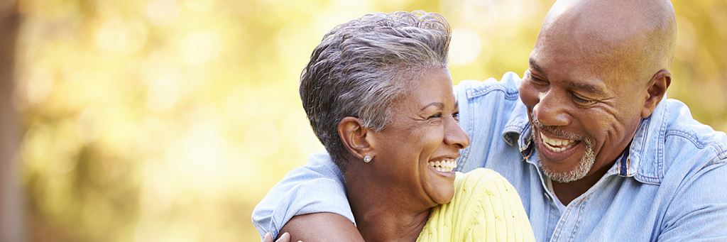 A senior couple laughs together during retirement.
