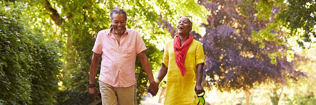 A senior couple walking outside.