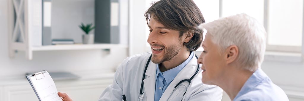 A woman and her doctor discuss paperwork.