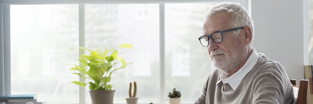 A senior man reading a newspaper.