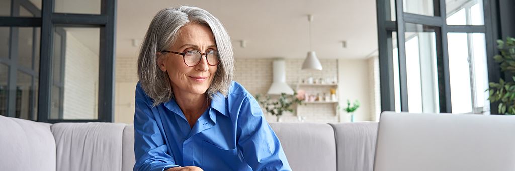 A woman writes on a piece of paper to calculate the future value of her annuity.