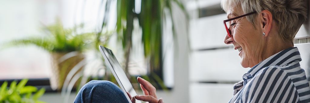 A woman calculates the present value of an annuity on a tablet.