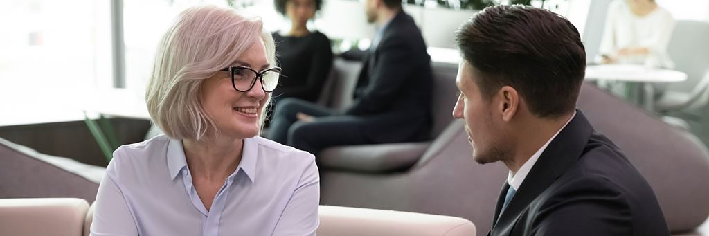 An older woman meets with a lawyer.