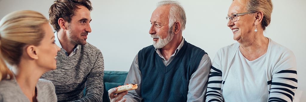 An older couple discusses life insurance policy changes with their two children.